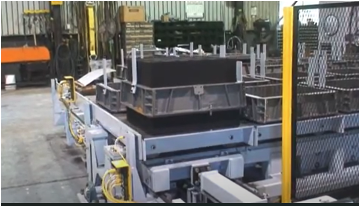 flasks on conveyor at aluminum foundry in Chicago, Illinois.