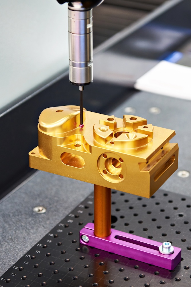 aluminum billet part machined and coated being checked on one of our coordinate measuring machines prior to shipping