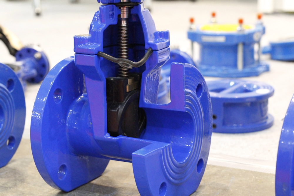 Blue cast iron gate valve for industrial piping wedge with rubber wedge. Throttle with gearbox. Manual valve.