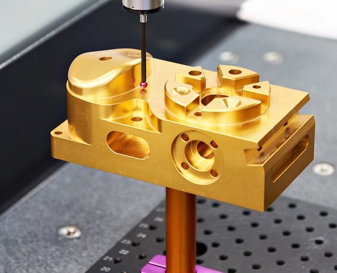 aluminum billet part machined and coated being checked on one of our coordinate measuring machines prior to shipping